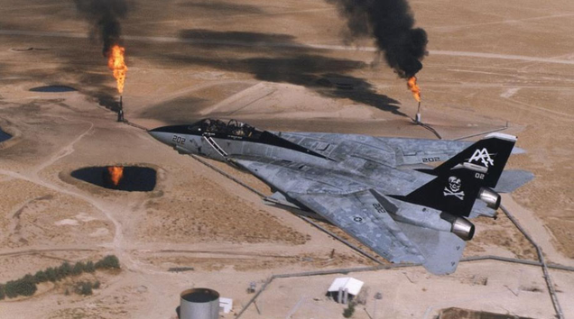 An F-14 Tomcat of VFA-103 “Jolly Rogers” flies over during oil wells during the Gulf War.